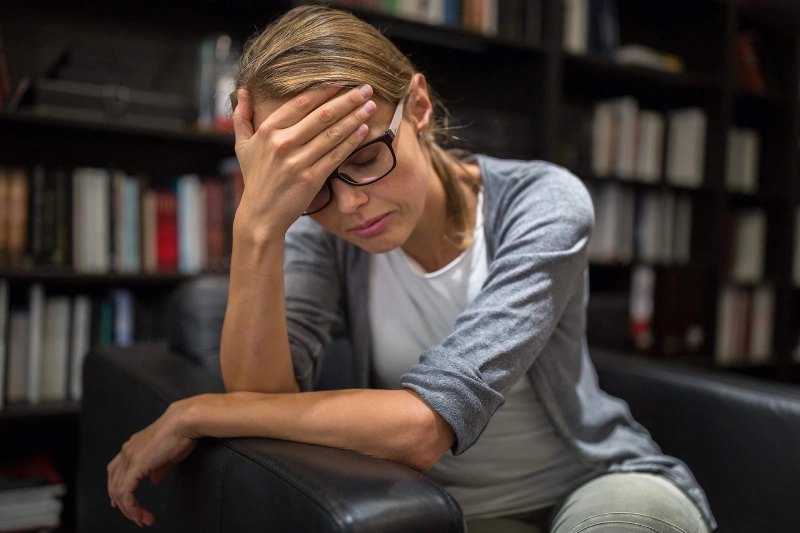 Woman experiencing headache and pain after car accident